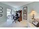 Bright office space featuring a desk, comfortable seating, and access to an enclosed lanai at 232 Southampton Ln # 259, Venice, FL 34293