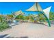 Inviting outdoor seating area with shade structures, picnic tables, and landscaping at 232 Southampton Ln # 259, Venice, FL 34293