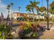 Charming street view with colorful planters, palm trees, and historic buildings at 232 Southampton Ln # 259, Venice, FL 34293