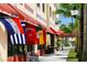 Charming Venice Mall storefront with colorful flags and inviting benches at 232 Southampton Ln # 259, Venice, FL 34293