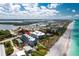 Stunning aerial view of a beachfront condo complex with turquoise waters and the white sands, highlighting its coastal location at 2380 N Beach Rd # 210, Englewood, FL 34223
