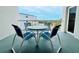 Outdoor balcony with seating for four, offering a perfect spot for relaxing and enjoying the surrounding views at 2380 N Beach Rd # 210, Englewood, FL 34223