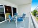 Cozy outdoor balcony features comfortable seating and partial views of the surrounding area at 2380 N Beach Rd # 210, Englewood, FL 34223
