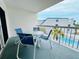 Balcony with outdoor seating, offering glimpses of the pool and nearby buildings at 2380 N Beach Rd # 210, Englewood, FL 34223