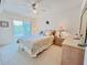 Cozy bedroom features a bed, dresser, and access to a private balcony at 2380 N Beach Rd # 210, Englewood, FL 34223