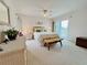 Relaxing bedroom with a comfortable bed, bench, and access to a private balcony at 2380 N Beach Rd # 210, Englewood, FL 34223