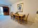 Dining area with a wooden table, seating for four, and natural light, adjacent to the living area at 2380 N Beach Rd # 210, Englewood, FL 34223