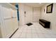 Inviting entryway with tile flooring, large closet, bench with storage, and front door at 2380 N Beach Rd # 210, Englewood, FL 34223