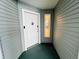 Inviting condo entrance featuring a white front door, decorative window, and neutral-toned siding for a modern look at 2380 N Beach Rd # 210, Englewood, FL 34223