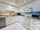 Well-equipped kitchen featuring modern appliances, white cabinetry, stylish countertops, and ample storage space at 2380 N Beach Rd # 210, Englewood, FL 34223