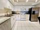Modern kitchen featuring stainless steel appliances, white cabinets, and granite countertops, for a clean, stylish look at 2380 N Beach Rd # 210, Englewood, FL 34223