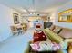 Inviting living room with floral accents, dining area, and kitchen view creating a comfortable living space at 2380 N Beach Rd # 210, Englewood, FL 34223