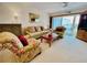 Relaxing living room with a sofa, an accent chair, a coffee table, and sliding doors to a private balcony at 2380 N Beach Rd # 210, Englewood, FL 34223