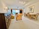 Inviting living room with comfortable seating, sliding glass doors to a balcony, and an adjacent dining area at 2380 N Beach Rd # 210, Englewood, FL 34223