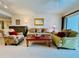 Comfortable living room featuring a sofa, accent chairs, a coffee table, and an inviting atmosphere at 2380 N Beach Rd # 210, Englewood, FL 34223