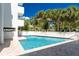 Community pool with clear blue water surrounded by palm trees and well-manicured landscaping at 2380 N Beach Rd # 210, Englewood, FL 34223