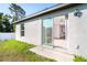 Exterior view of sliding glass door in backyard, leading into a living area with natural light at 2408 Bonanza Ln, North Port, FL 34286