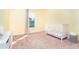 room with yellow walls, pink heart decals, a white crib and pink and yellow patterned curtains at 2408 Bonanza Ln, North Port, FL 34286