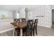 Dining room with dark wood table and four chairs, as well as patterned wallpaper at 2408 Bonanza Ln, North Port, FL 34286
