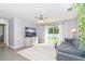 Well-lit living room with a comfortable couch and sliding glass door to the backyard at 2408 Bonanza Ln, North Port, FL 34286