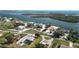 Expansive aerial view of waterfront neighborhood with houses and boat docks nestled along the picturesque coastline at 310 Green Dolphin Dr, Placida, FL 33946