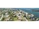 Panoramic aerial view of a waterfront neighborhood featuring luxurious homes and lush greenery by the tranquil coast at 310 Green Dolphin Dr, Placida, FL 33946