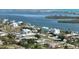 Picturesque aerial view of waterfront homes with docks in a neighborhood along the serene coastline, with lush greenery at 310 Green Dolphin Dr, Placida, FL 33946