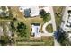 Top-down aerial perspective showcases the home's solar panels, manicured lawn, and the circular driveway at 310 Green Dolphin Dr, Placida, FL 33946