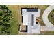 Overhead aerial view captures the home's roof covered in solar panels, along with the well-kept lawn and circular driveway at 310 Green Dolphin Dr, Placida, FL 33946