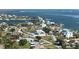 Scenic aerial view showcases waterfront homes in a neighborhood with winding roads along the tranquil coastal waterways at 310 Green Dolphin Dr, Placida, FL 33946