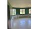 Bright bedroom showcasing multiple windows and a view of the outdoors at 310 Green Dolphin Dr, Placida, FL 33946