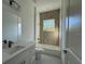 Clean bathroom with a vanity, toilet, and a shower/tub combo with tiled wall at 311 Yule St, Port Charlotte, FL 33953