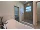 Bright bathroom showcasing a soaking tub and a walk-in shower with modern finishes at 311 Yule St, Port Charlotte, FL 33953