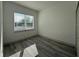 Bright bedroom featuring a window and wood-look floors, with a closet to the side at 311 Yule St, Port Charlotte, FL 33953