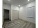 Cozy bedroom with wood-look floors, a window with blinds, and a closet at 311 Yule St, Port Charlotte, FL 33953