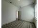 Spacious bedroom featuring wood-look floors, neutral walls, and a window at 311 Yule St, Port Charlotte, FL 33953