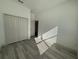 Spacious bedroom with wood-look flooring and a closet, illuminated by natural light at 311 Yule St, Port Charlotte, FL 33953
