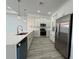 Modern kitchen featuring stainless steel appliances, white cabinets, and quartz countertops at 311 Yule St, Port Charlotte, FL 33953