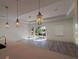 Bright living room with tray ceiling, recessed lights, wood floors, and sliding glass doors at 311 Yule St, Port Charlotte, FL 33953