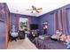 Cozy bedroom features plush carpet, ceiling fan and ample natural light from the window, creating an inviting space at 3261 Rogue St, North Port, FL 34291