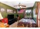 This room features an olive drab paint scheme, complemented by decor and a ceiling fan, blending style with a touch of coziness at 3261 Rogue St, North Port, FL 34291
