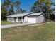 Gray home with a two-car garage and a paved driveway at 3261 Rogue St, North Port, FL 34291