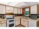 Bright kitchen with double oven, dishwasher, ample cabinets, and stylish backsplash at 3261 Rogue St, North Port, FL 34291