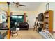 Cozy living room with carpeted floors, a sofa, a TV, and a sliding glass door to the backyard at 3261 Rogue St, North Port, FL 34291