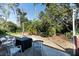 Outdoor patio area with outdoor furniture, surrounded by greenery and shade at 3261 Rogue St, North Port, FL 34291