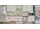 Contemporary kitchen featuring white cabinets, stainless appliances, and granite countertops at 39 1St Ave, Englewood, FL 34223