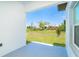 Open backyard view from the covered patio, highlighting the spacious lawn and landscaping at 398 Sunset N Rd, Rotonda West, FL 33947