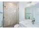 Modern bathroom featuring a glass-enclosed shower, white vanity, and elegant fixtures at 398 Sunset N Rd, Rotonda West, FL 33947
