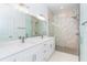 Modern bathroom featuring dual sinks, quartz counters, and a glass-enclosed shower with stone tile at 398 Sunset N Rd, Rotonda West, FL 33947