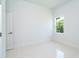 Well-lit bedroom with white tile floors and a bright window at 398 Sunset N Rd, Rotonda West, FL 33947
